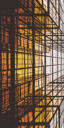 Golden light reflected across a glass building facade