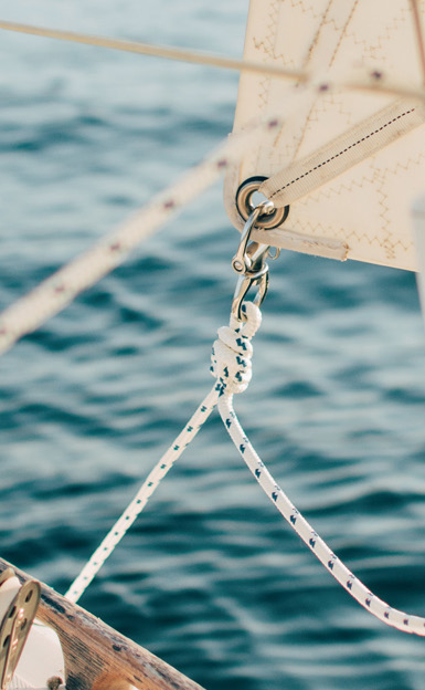 Sailboat rigging knotted and secured above open water